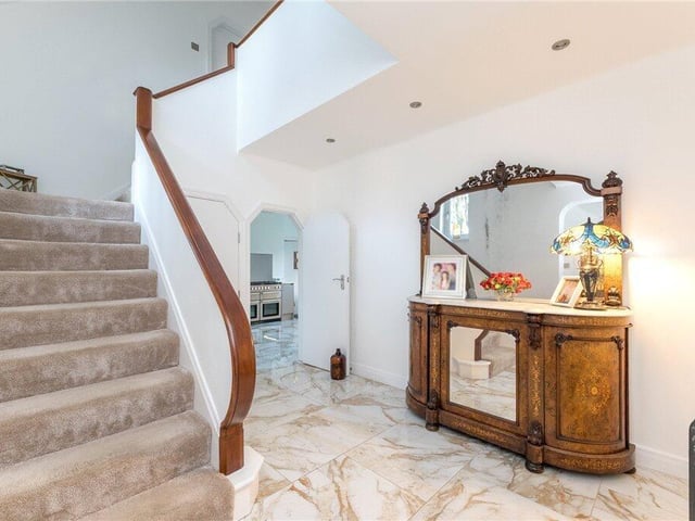 The ground floor features a spacious entrance hall with a ceramic tiled floor that extends through to the dining kitchen.