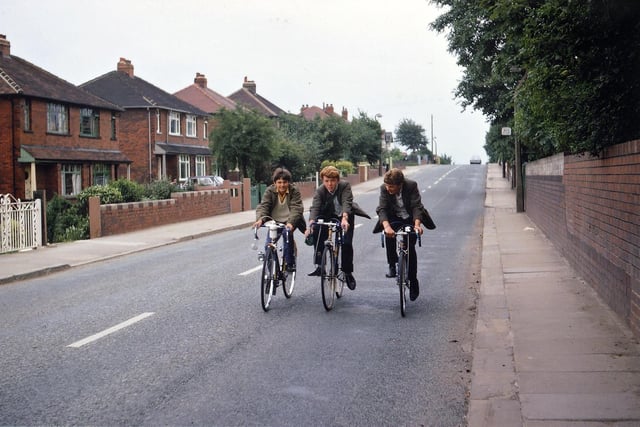 Three young cyclists, Peter Morris, Vincent Wainwright and Steven Entwhistle are pictured riding along Rein Road in July 1968. Eventually, the M62 was to cut across Rein Road and the houses on the left, near to where the car is visible, were shortly to be demolished.