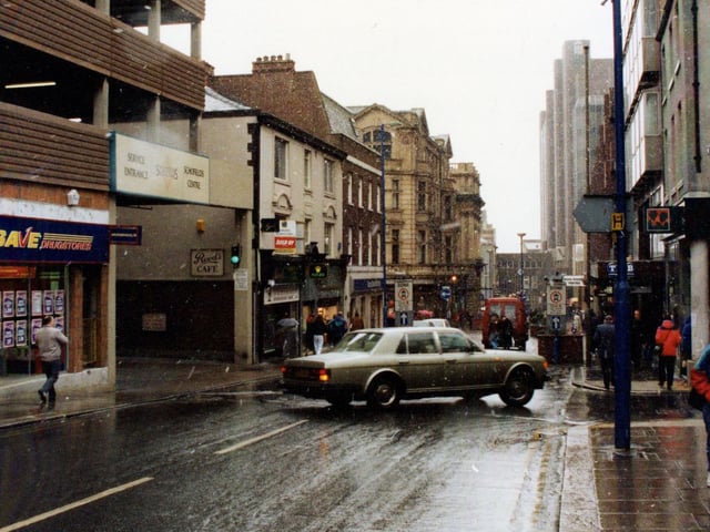 Albion Street in February 1991.  On the left is Supersave Drugstore then the loading bay and service entrance of Schofields Centre, with the multi-storey car park above. On the right, beyond the junction with Butts Court, are the Bradford and Bingley Building Society and the Trustee Savings Bank.