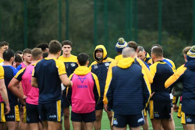 Rhinos coach Rohan Smith (with hood) talks to his players at training on Tuesday. Picture by Jonathan Gawthorpe.