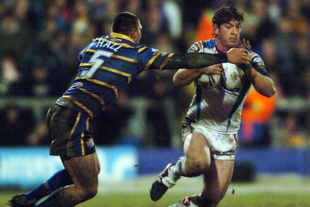 Jason Demetriou, of Wakefield Trinity, attempts to evade Leeds Rhinos' Ryan Hall in February, 2009. Picture by Jonathan Gawthorpe.