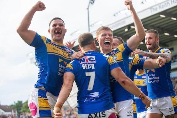 Zak Hardaker, right, joins in the celebrations after Aidan Sezer's winning try for Rhinos against Castleford.  Picture by Bruce Rollinson/SWpix.com.
