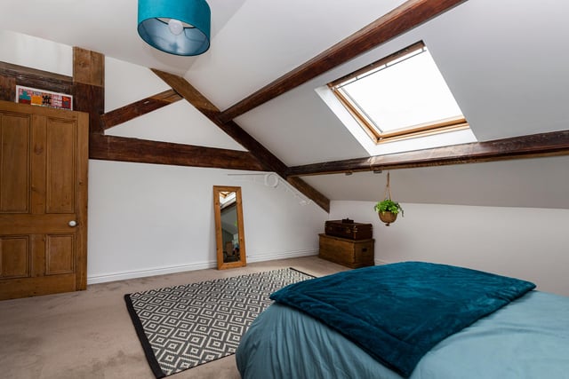 This beamed bedroom with Velux window has plenty of floor space for free standing furniture.