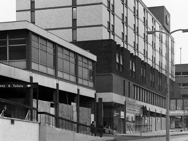 The Merrion Hotel on Wade Lane with the Merrion Centre below. On the left a sign directs towards the subway and toilets now disused.