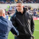 Warrington Wolves coach Sam Burgess, right, shakes hands with Leeds Rhinos rival Brad Arthur ahead of the sides' meeting at AMT Headingley in March. Picture by Alex Whitehead/SWpix.com.