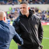 Warrington Wolves coach Sam Burgess, right, shakes hands with Leeds Rhinos rival Brad Arthur ahead of the sides' meeting at AMT Headingley in March. Picture by Alex Whitehead/SWpix.com.