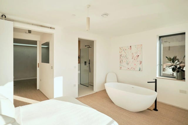 The double-aspect main suite has a shower room, plus glazed doors opening to a Juliet balcony with expansive river views.