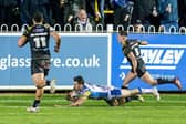 Paul Momirovski, seen scoring during Leeds Rhinos' win at Castleford Tigers in March, is back in the squad for Saturday's rematch. Picture by Allan McKenzie/SWpix.com.