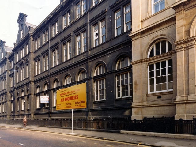 View of the side of the General Post Office building from Quebec Street. It fronts on to City Square, off to the right, and was designed in a Renaissance style by the Board of Work's architect Henry Tanner. It was built at a cost of £75,000 and opened in 1896. This image from April 1979 has a sign saying 'All Enquiries' superimposed on the image by the planning department.