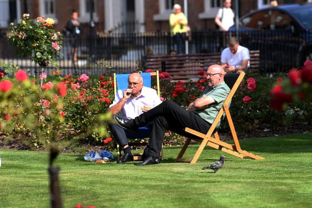 People sit out and enjoy the sunshine at Park Square, Leeds. Picture: Simon Hulme