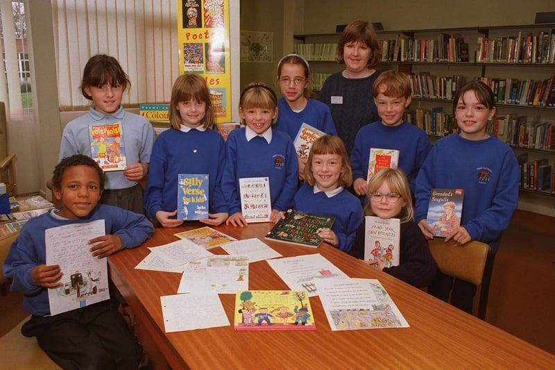 Pupils with poetry prizes at Beeston's Hugh Gaitskell Primary School in November 1996. Pictured, back row from left, are Duncan McBurney, Heather Smith, Emma Earnshaw, Sarah Reed, Sarah Frankland, Danny Gray and Cathryn Gander. Seated, from left, are Katherine Wilkinson, Samantha Worth. The adult in the photo is Janet Clark of the Children's Library South Leeds.