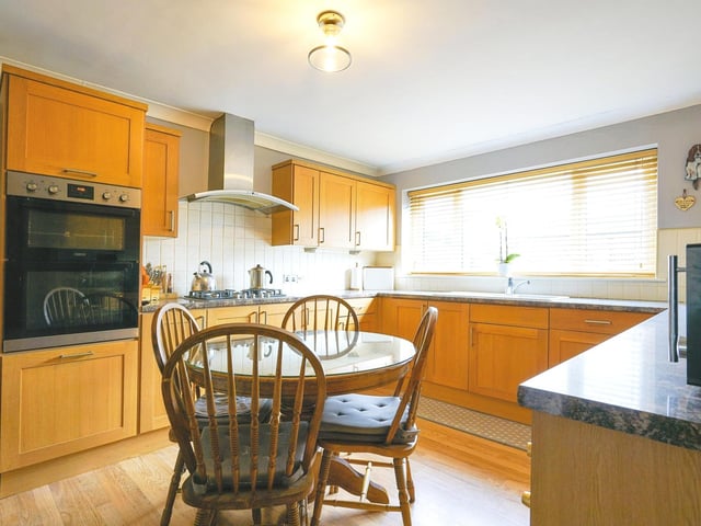 The kitchen has a range of matching wall and base units with a gas hob, electric integrated oven, integrated dishwasher and plumbing for washing machine.