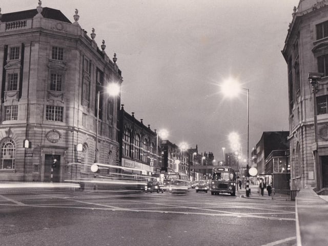 A night scene at the junction of Vicar Lane and The Headrow.