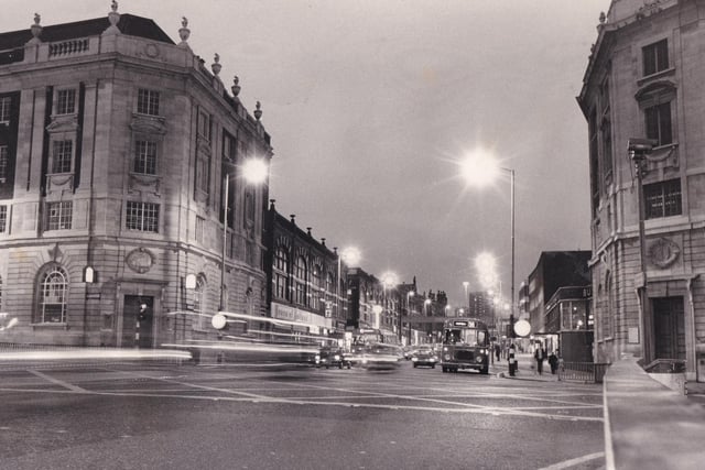 A night scene at the junction of Vicar Lane and The Headrow.