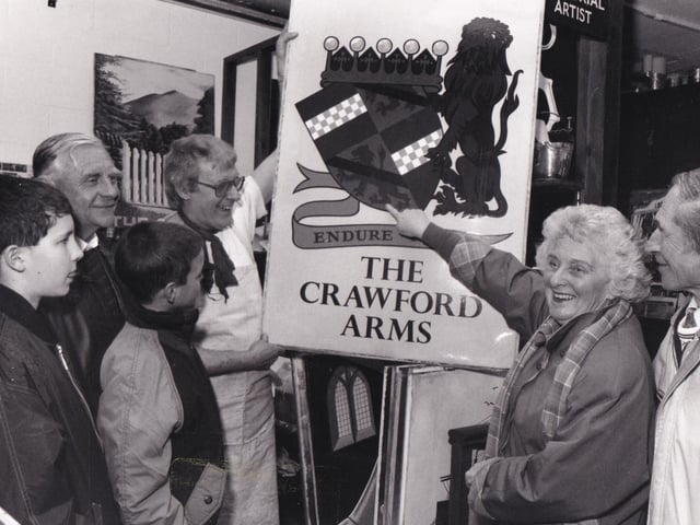 Tetley's sign writer Richard Cale shows visitors a selection of the brewery's pub signs.