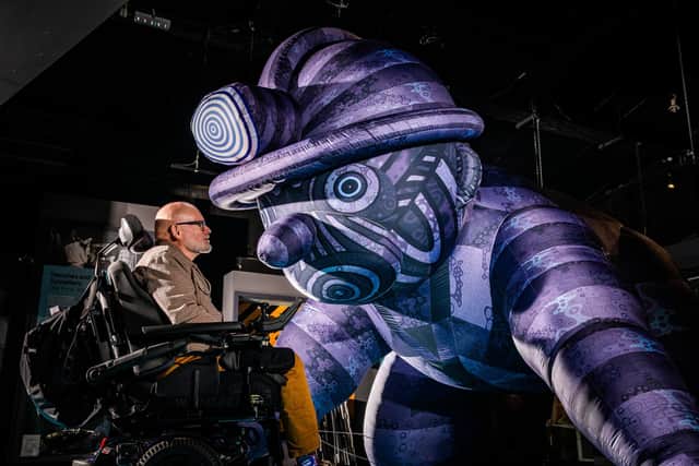 The National Coal Mining Museum has a groundbreaking  art project celebrating the heritage and human stories of Britain's mining communities. A world first tapestry has been created by acclaimed disabled artist Jason Wilsher-Mills MBE, marking one of the most ambitious commissions of his career. Pictured Artist Jason Wilsher-Mills MBE, next to his Inflatable sculpture Titled: Crawling Miner, 2026, (Nylon, LED, Lights and Air Pump). Picture: James Hardisty.