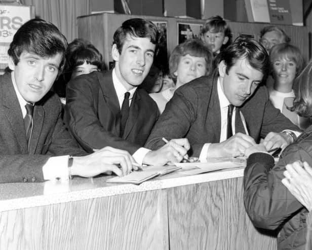 The Bachelors are pictured signing autographs and copies of their latest record. In 1964 the Bachelors released the singles, 'Diane', 'Ramona', 'I believe', 'I Wouldn't Trade You For The World', and 'No Arms Could Ever Hold You'.