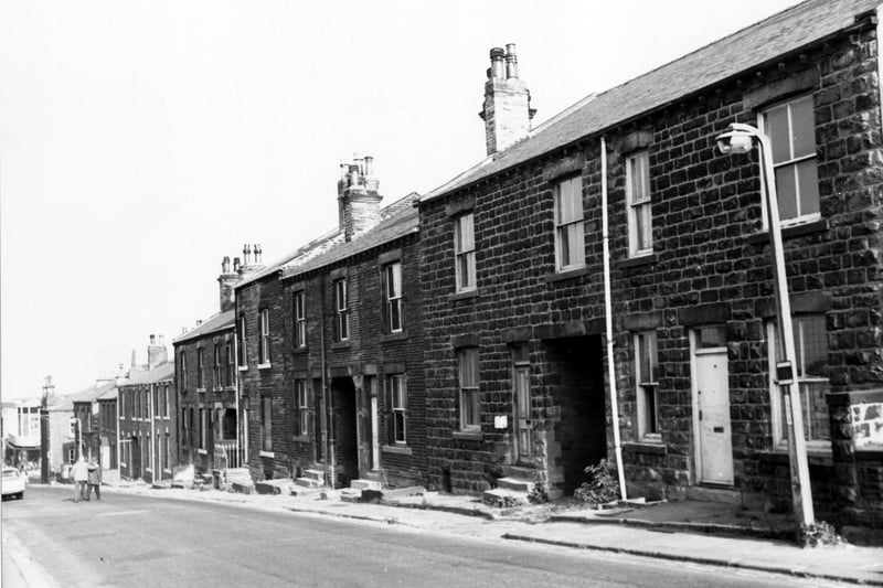 Albion Street in July 1971. The terraced houses have small yards at the front to separate them from the pavement. Ginnels run between the houses providing access to the rear of the properties.
