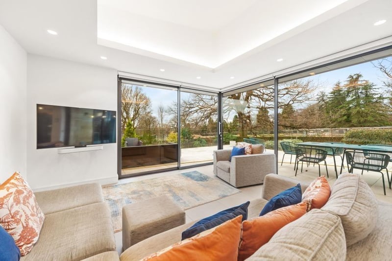 Open and comfortable space, with a green vista visible through the windows of the bi-fold doors.