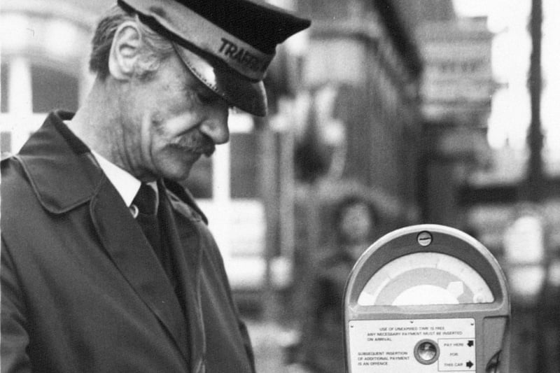 A traffic warden studies one of the new parking meters in Park Square in October 1981.