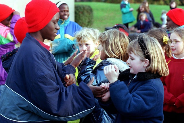 Members of The African Children's Choir play with pupils of Primrose Lane Primary during a school day in November 12999. The choir was on a nine month tour of Britain at the time.