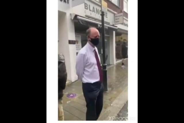 Prof Whitty - who is waiting for a takeaway lunch order at a street stall - does not respond to the taunts in the video (Photo: TikTok)