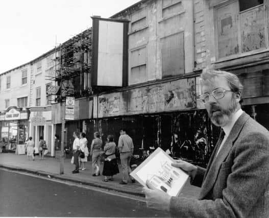 The First White Cloth Hall on Kirkgate was built in 1711 for the sale of undyed cloth, a role successively taken on by the second, third and fourth White Cloth Halls. Today only the first and third survive. Pictured here is the chairman of Leeds Civic Trust, Dr. Kevin O'Grady, outside the hall in 1991.