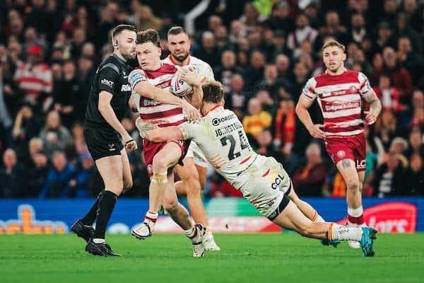 Wigan’s Jai Field is tackled by Catalans’ former Wakefield winger Tom Johnstone. Picture by Alex Whitehead/SWpix.com.