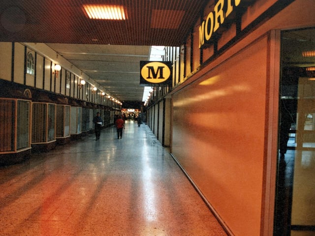 Empty office fronts run down the left. On the right is the branch of Morrisons.
