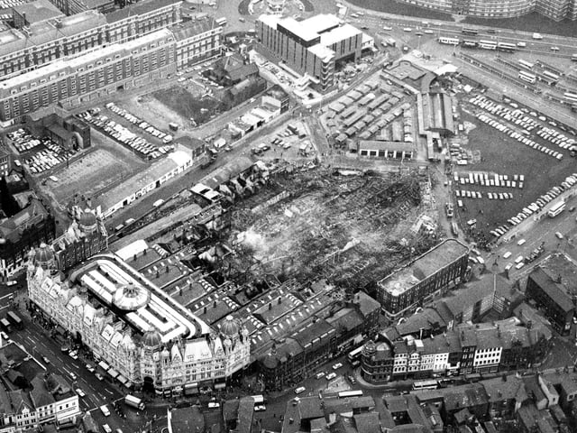 Aerial view looking across the destruction caused by a fire in Kirkgate Market, seen in the direction of the Eastgate roundabout. Around 4 acres of the site was destroyed in a blaze which took 110 fireman two hours to control. Most of the 1857 section of the market was destroyed although the 1904 frontage onto Vicar Lane was saved. This section, containing Butchers Row, seen to the left, reopened on Tuesday 16th December. Many of the other stalls found temporary locations in the Corn Exchange, and the George Street and Harewood Street Car Parks. A visit from Prince Charles on the 17th boosted the morale of stall holders hit by the fire.