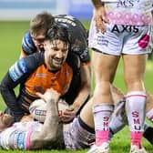 Blake Austin is tackled by Gareth Widdop and Jack Broadbent during Rhinos' defeat at Castleford in March. Picture by Allan McKenzie/SWpix.com.