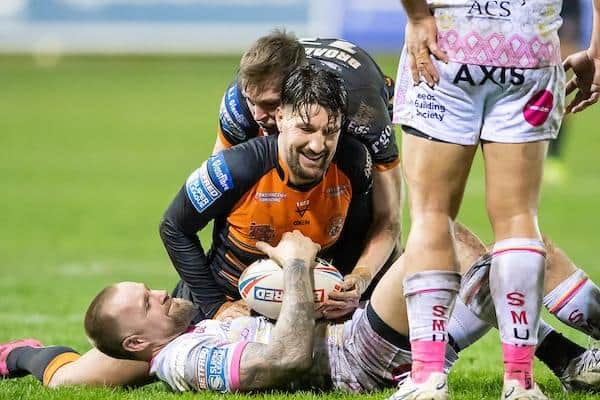 Blake Austin is tackled by Gareth Widdop and Jack Broadbent during Rhinos' defeat at Castleford in March. Picture by Allan McKenzie/SWpix.com.