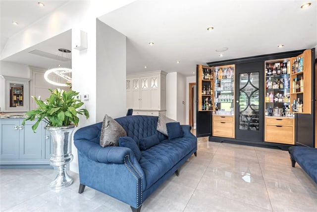 Open access leads to a family snug seating area, with patio doors opening out onto the garden. Leading off from the kitchen is a butler's pantry.