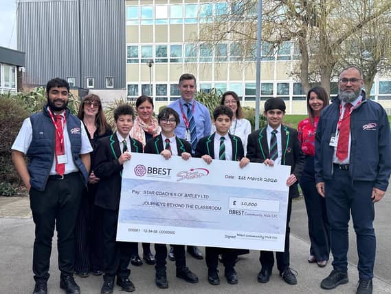 Students with representatives from BBEST Community Hub CIC and Star Coaches of Batley Ltd celebrating a £10,000 partnership to support educational trips for local schools.
