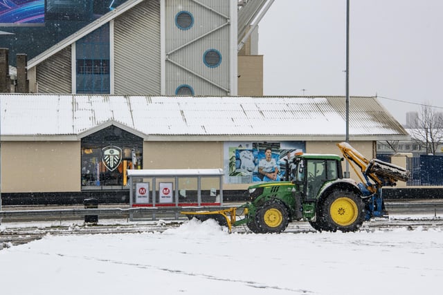 Work to clear the heavy snowfall in the area around Elland Road in preparation for Leeds United's  Premier League match with Brighton and Hove Albion.