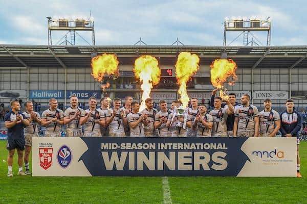 George Williams lifts the trophy after England men's 64-0 victory over France. Picture by Olly Hassell/SWpix.com.