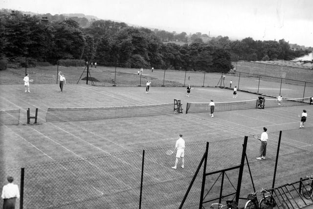 The playing field and tennis courts at Aireborough Grammar School in 1955. The school was opened in 1910 as Yeadon and Guiseley Secondary School. The name was later changed to Aireborough Grammar School. By the 1980s, it was said that pupil numbers were falling and the building was closed in 1991. After demolition a housing estate was built on the land. To the right on this view can be seen the wall which marked the boundary of Peates mill, and some of the factory units.