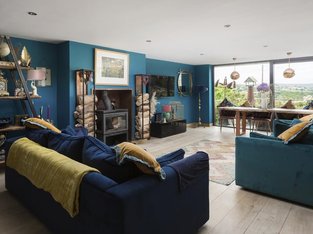A warming stove is a central feature of this room, that has spotlights to the ceiling.