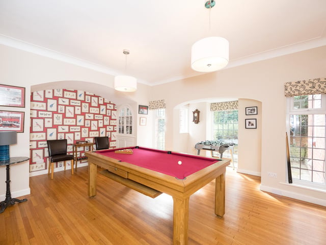 This games room has plenty of natural light pouring in through the large windows.