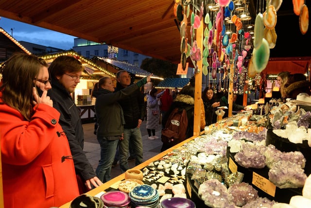 Here visitors to the market in 2017 browse the goods on sale, ranging from trinkets to decorative pots for the perfect Christmas gift.
