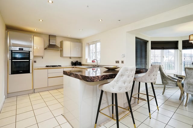 The outstanding kitchen is the main focal point of downstairs, with gorgeous marble worktops and modern appliances.