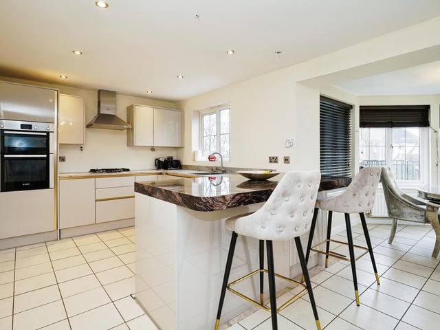 The outstanding kitchen is the main focal point of downstairs, with gorgeous marble worktops and modern appliances.