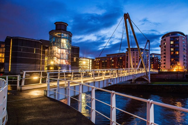 Leeds Dock and the Royal Armouries lit up as night falls.