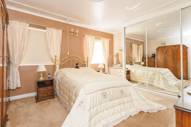 One of the property's double bedrooms, with mirrored wardrobes.