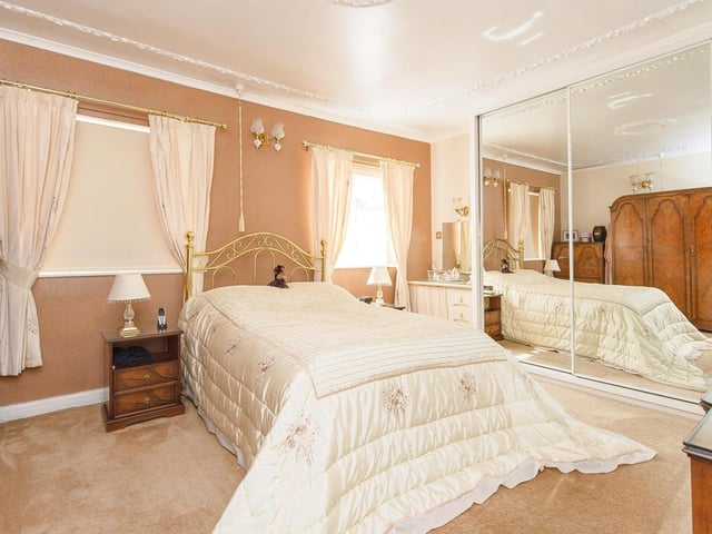 One of the property's double bedrooms, with mirrored wardrobes.