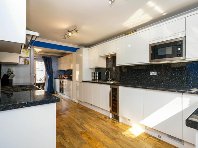 Once inside the property there is a spacious modern kitchen with integrated wine fridges, a stylish floor and ceiling fitted cupboards.