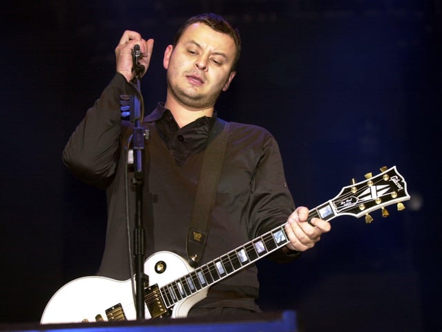 James Dean Bradfield of the Manic Street Preachers adjusts his mic on stage in 2001. They band have sold more than ten million albums worldwide.