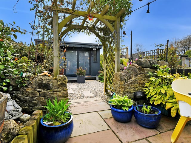 To the rear of the property, the landscaped garden provides a haven of tranquility, with a variety of flowering plants and shrubs creating a peaceful and private oasis.