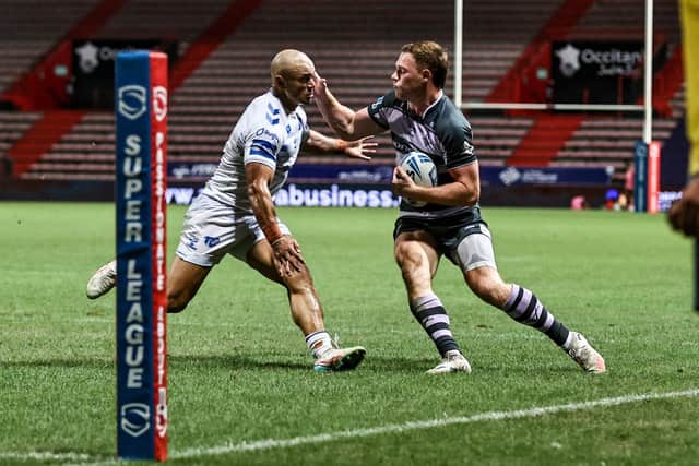 Huddersfield Giants' Sam Halsall fends off Paul Ulberg of Toulouse Olympique. Last Saturday's game was Giants' fourth successive win and Toulouse's fourth straigt defeat. Picture by Simon Hall/SWpix.com.