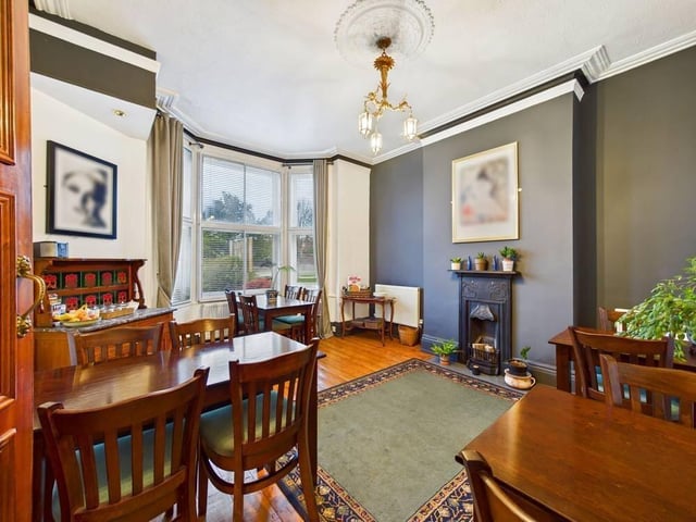 The dining room has a feature fireplace, wood flooring, a central heated radiator and a UPVC double glazed bay window to the front.